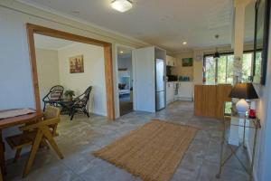 a living room with a kitchen and a dining room at Daniu Ocean View Garden House in Merimbula