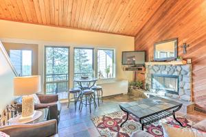 a living room with a fireplace and a table at Breathtaking Bend Condo with Resort Amenities! in Bend
