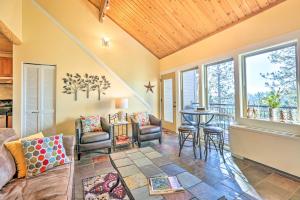 a living room with a couch and a table at Breathtaking Bend Condo with Resort Amenities! in Bend