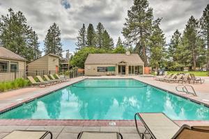 a swimming pool with chairs and a house at Breathtaking Bend Condo with Resort Amenities! in Bend