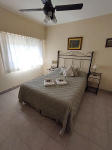 a bedroom with a bed with two trays on it at Costa Norte Hostería in Colón