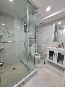 a bathroom with a shower and a toilet at Falstaff Home in Toronto