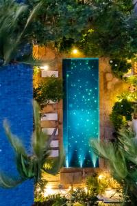 a door in a building with trees and lights at CasaLô Hotel in Jericoacoara