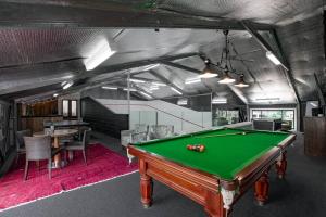 a pool table in the middle of a room at Kalinya Estate Platinum- Homestead, Lodge & Barn- up to 34 guests in Bargo