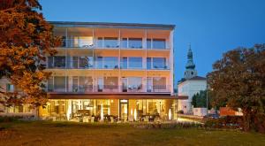 a large building with tables and chairs in front of it at At the Park Hotel in Baden +37 photos