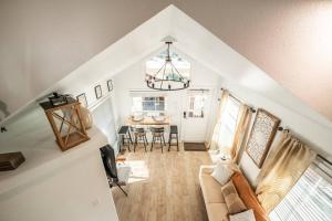 a living room with a couch and a dining room at NEW! Boutique TinyHome w/Direct View of PikesPeak! in Woodland Park
