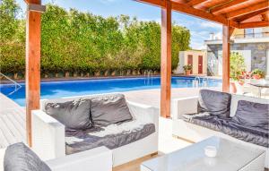 un patio con muebles blancos y una piscina en Lovely Apartment In Bolnuevo With Wifi en Bolnuevo