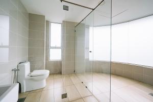 a bathroom with a toilet and a glass shower at Sky Bungalow NIlai by James NEARBY KLIA, KLIA 2, CYBERJAYA, PUTRAJAYA in Nilai