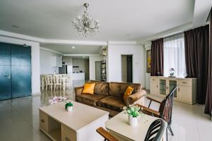 a living room with a couch and a table at Sky Bungalow NIlai by James NEARBY KLIA, KLIA 2, CYBERJAYA, PUTRAJAYA in Nilai