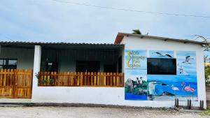 a building with posters on the side of it at Hostal Punta Arena in Puerto Villamil