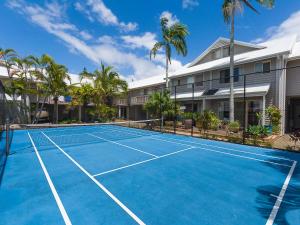 a tennis court in front of a building at 7 Pelican Beach Resort in Noosaville +3 photos