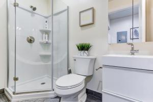 a white bathroom with a toilet and a sink at Marbella Lane - Bright and Cozy Home near SFO in San Mateo