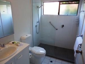 a bathroom with a shower and a toilet and a sink at Unit 2 Riverbreeze in Noosaville