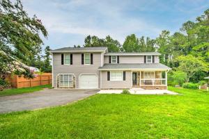 a house with a green lawn in front of it at Picturesque Kennesaw Home with Private Backyard in Kennesaw