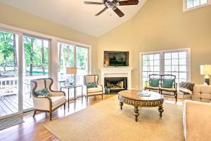 a living room filled with furniture and a fireplace at Stunning Lake Oconee Retreat with Pool Access! in Turnwold