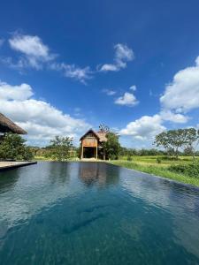 a large pool of water in front of a building at Rock Shade Chalet- Sigiriya in Sigiriya