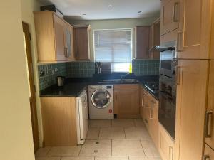 a kitchen with a washing machine and a dishwasher at Shared house on Southmead in Bristol