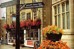 a street sign in front of a building with flowers at Spacious Cabin with Private Hot Tub, and Private Pool, in 5 Acres - intimate Special stay For 2 Adults - plus 1 child under 2 and up to 2 dogs stay for free in Downham