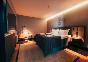 a bedroom with a bed in a room with lights at Clarion Hotel Mestari in Helsinki