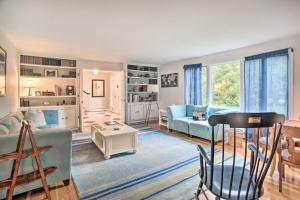 a living room with a couch and a table at Falmouth Retreat with Deck and Grill, Walk to Beaches! in Falmouth