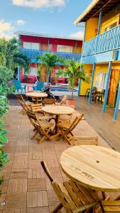 a group of wooden tables and chairs on a patio at Be Happy Hotel in San Andrés