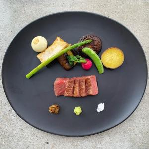 a plate of food with meat and vegetables on it at Entô in Ama