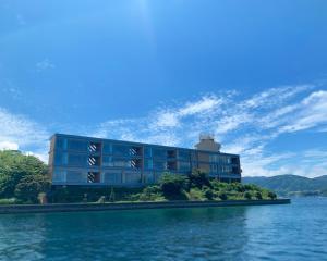 a building on an island in a body of water at Entô in Ama