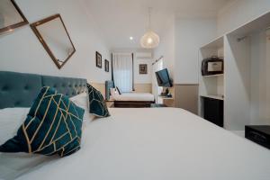 a bedroom with a large white bed with pillows at Cremorne Point Manor in Sydney