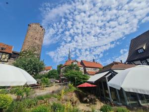 a view of a city with a tower and buildings at Hotel & Café Schachtenburg in Schlitz