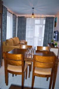 a living room with a table and chairs and a couch at One bedroom apartment in Nairobi