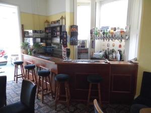 a bar with stools in a room at The Sandhill in Sandown