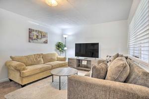 a living room with two couches and a flat screen tv at Low-Key Columbus Apartment - Great Location! in Columbus