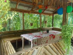 a table in the middle of a room with trees at Kasturi Farmstay by StayApart in Bijanbāri Bāzār