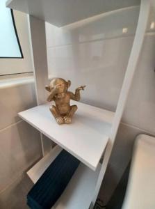 a small teddy bear sitting on a white shelf at Lucky Summer Marsalforn Holiday Apartment in Marsalforn