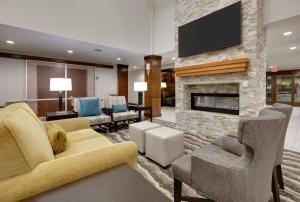a living room with a fireplace and a tv at Staybridge Suites - San Antonio - Schertz, an IHG Hotel in Schertz