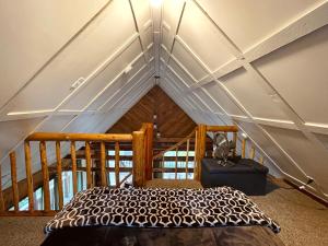 Mt Rainier Little Red Cabin في أشفورد: غرفة نوم مع سرير في العلية