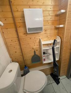 a bathroom with a toilet and a air conditioner on the wall at Studio 2 pers Piau Engaly Le Gypaète résidence Moudang I in Aragnouet