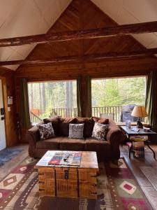 a living room with a couch and a coffee table at Mt Rainier Little Red Cabin in Ashford