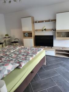 a bedroom with a bed and a tiled floor at Gästewohnung 1 in Oschersleben