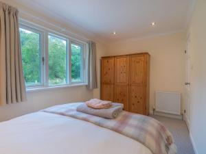 a bedroom with a bed with two towels on it at Cuil Bay Lodge in Acharra