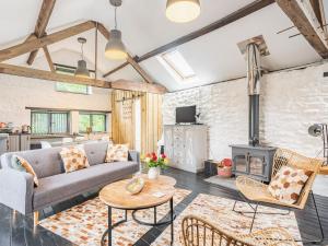 a living room with a couch and a fireplace at The Barn in Newbridge on Wye