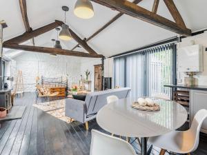 a kitchen and living room with a table and chairs at The Barn in Newbridge on Wye