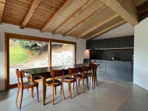 a kitchen with a dining room table and chairs at Casa Campanula in Laax