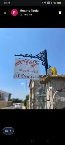 a sign is posted on a ledge of a building at B&B Il Sentiero in San Sperate