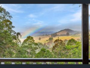 a view of a rainbow from a window at Bluegums Cabins Barrington Tops in Bandon Grove