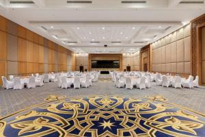 a banquet hall with white tables and white chairs at Pickalbatros The Palace Port Ghalib in Port Ghalib