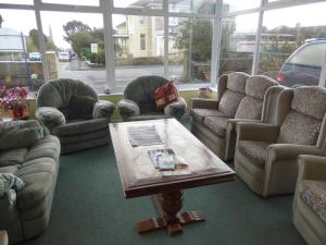 a living room with couches and a coffee table at The Sandhill in Sandown