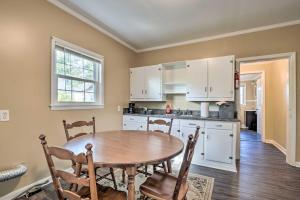 a kitchen with a table and chairs in a room at Cozy Greenville Bungalow about 2 Mi to Downtown! in Greenville