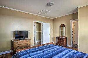 a bedroom with a bed and a flat screen tv at Cozy Greenville Bungalow about 2 Mi to Downtown! in Greenville