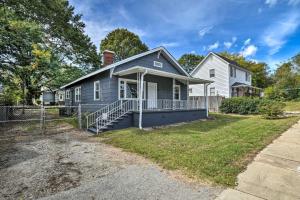 a blue house with a porch and a white house at Cozy Greenville Bungalow about 2 Mi to Downtown! in Greenville